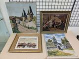 three paintings on display on a table in a room