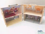 two doll houses that are made out of wood