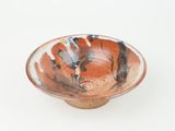 a small bowl that is sitting on a white surface