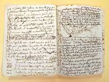 an old book with writing on it sitting on top of a table