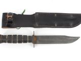 knife and sheath on a white surface with a white background