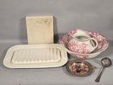 a table with a bowl, tray, spoon, and other items on it