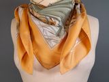 yellow and gray scarf on a mannequin torso