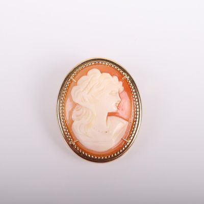 a close up of a broochee with a woman ' s face on it