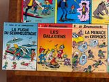 several children ' s books are lined up on a wooden table