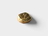 a close up of a gold ring on a white surface