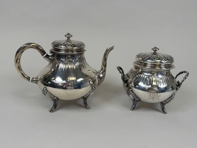 two silverplated teapots and a sugar bowl