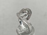 a close up of a silver ring with diamonds on it