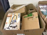a box with a vacuum in it sitting on the floor
