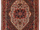 a red and black rug with a medallion design on it