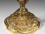 a gold candle holder on a white table