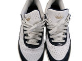 a pair of white and blue sneakers on a white surface