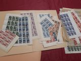 a lot of stamps on a table with a red table cloth