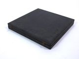 an old black book sitting on top of a white table