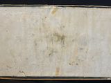 an old book sitting on top of a black table