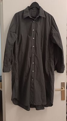 black shirt hanging on a white door in a room