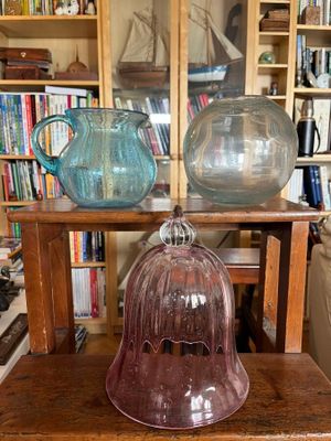 two vases sitting on a wooden table in a living room