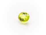 a yellow sapphire stone on a white background