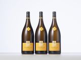 three bottles of wine sitting on top of a table