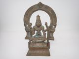 an image of a bronze statue of a woman sitting on a throne