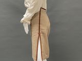 a mannequin wearing a tan skirt and white blouse