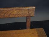 a close up of a wooden chair with a black background