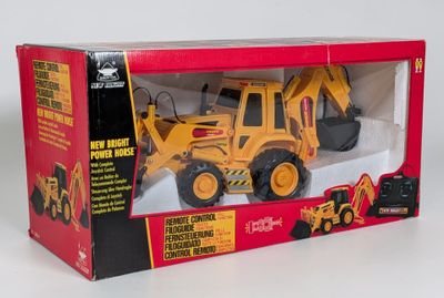 toy construction vehicle in a box on a white surface