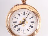 a gold pocket watch with roman numerals on the face