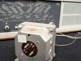 an old radio sitting on the floor next to a wall