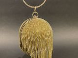 a gold beaded purse with a chain around it