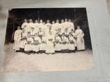 a group of women in white dresses posing for a picture