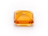an orange sapphire stone on a white background