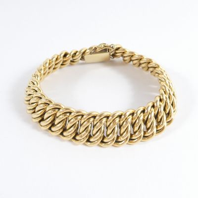 a yellow gold bracelet with a braid design