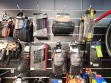many different types of shoes and bags on the wall