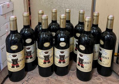 several bottles of red wine are lined up on a counter