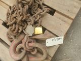 a wooden pallet with a bunch of chains on it