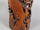 an image of a wooden vase with a bird on it