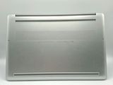 an open laptop computer sitting on top of a white surface