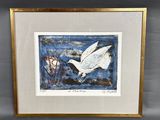 a framed picture of a bird flying over a body of water