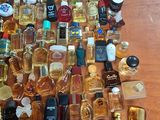 a lot of perfume bottles on the table with a price tag