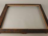 an old wooden frame with a glass window on top of it