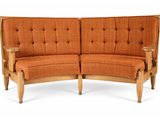 orange upholstered loveseat with wood frame and tufted upholstered cushions