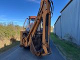 an image of a tractor that is parked on the side of the road