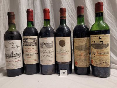 several bottles of wine are lined up on a table