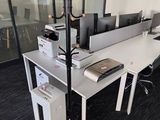 an image of an office cubicle with multiple computers on it