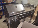 an image of a stainless steel grill in a garage