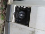 a white stove top oven sitting on the side of the road