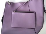 a purple handbag with a zipper on top of it