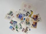 a pile of stamps on a table with a white background