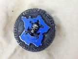 a metal button with a skull and crossbone on it